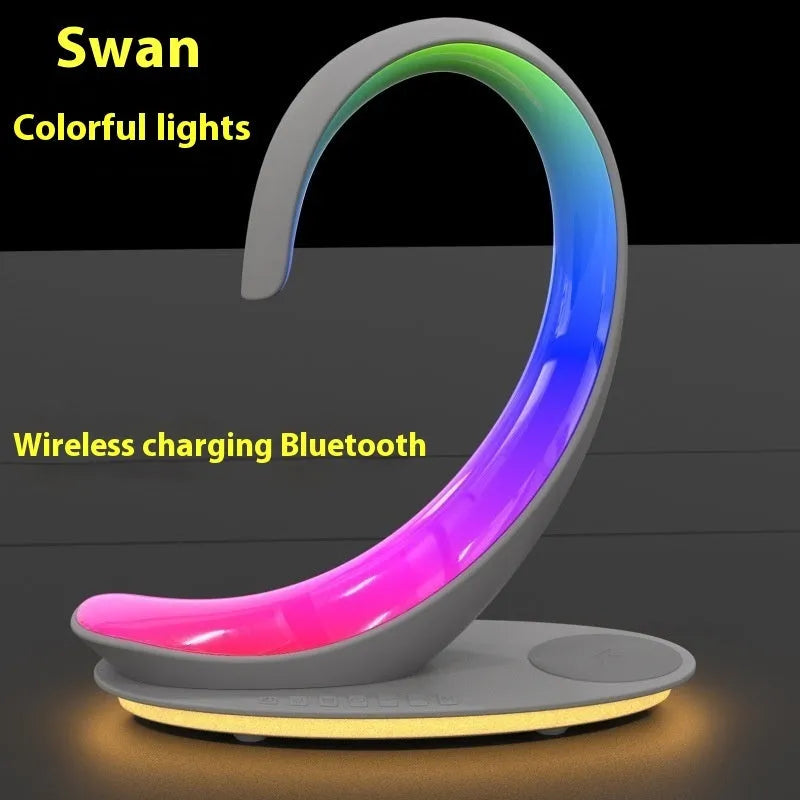 White swan-shaped desktop lamp with wireless charging pad, Bluetooth speaker and colourful atmospheric lighting effects