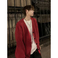 Men's loose-fit V-neck knit cardigan in army green, shown on a hanger.