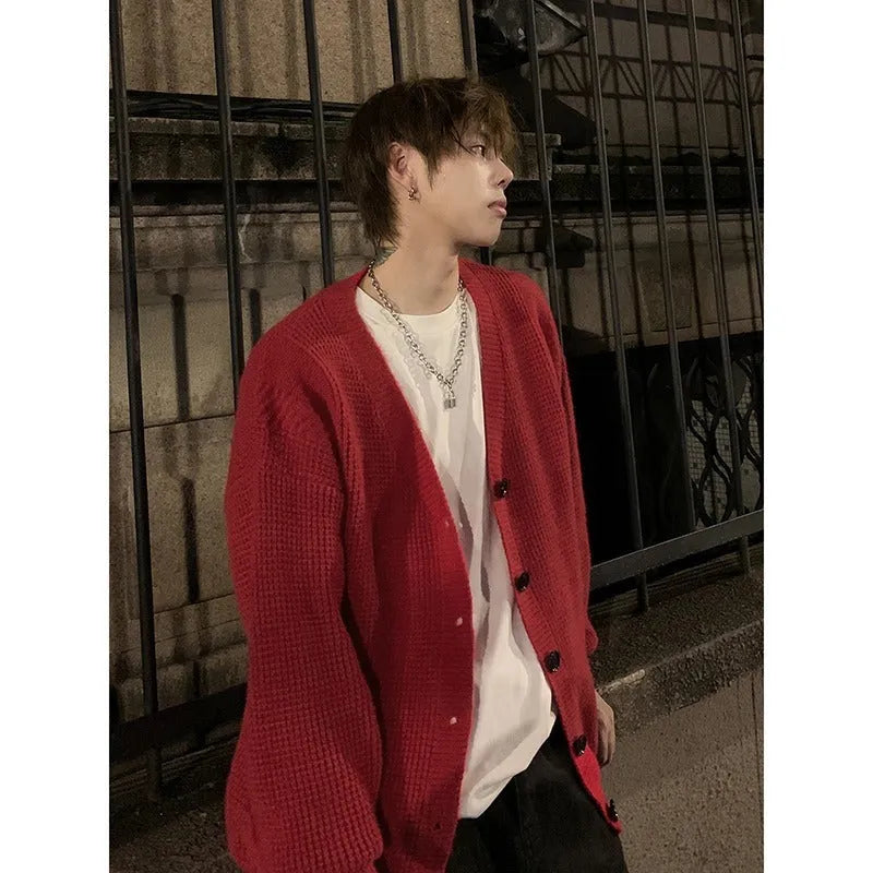 Men's loose-fit V-neck knit cardigan in army green, shown on a hanger.