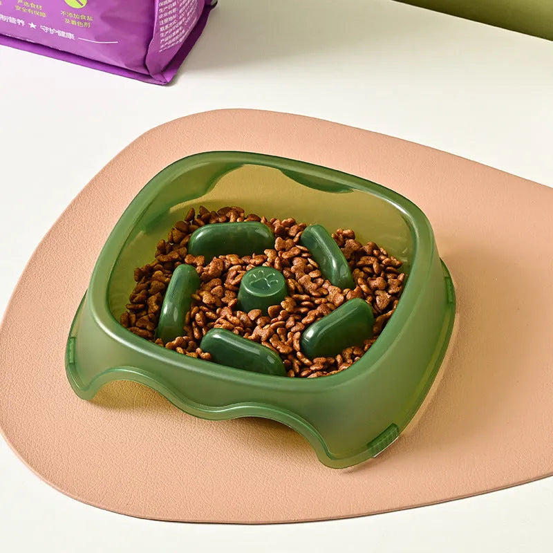 Blue plastic slow feeder dog bowl for anti-choking feeding on a plain surface.