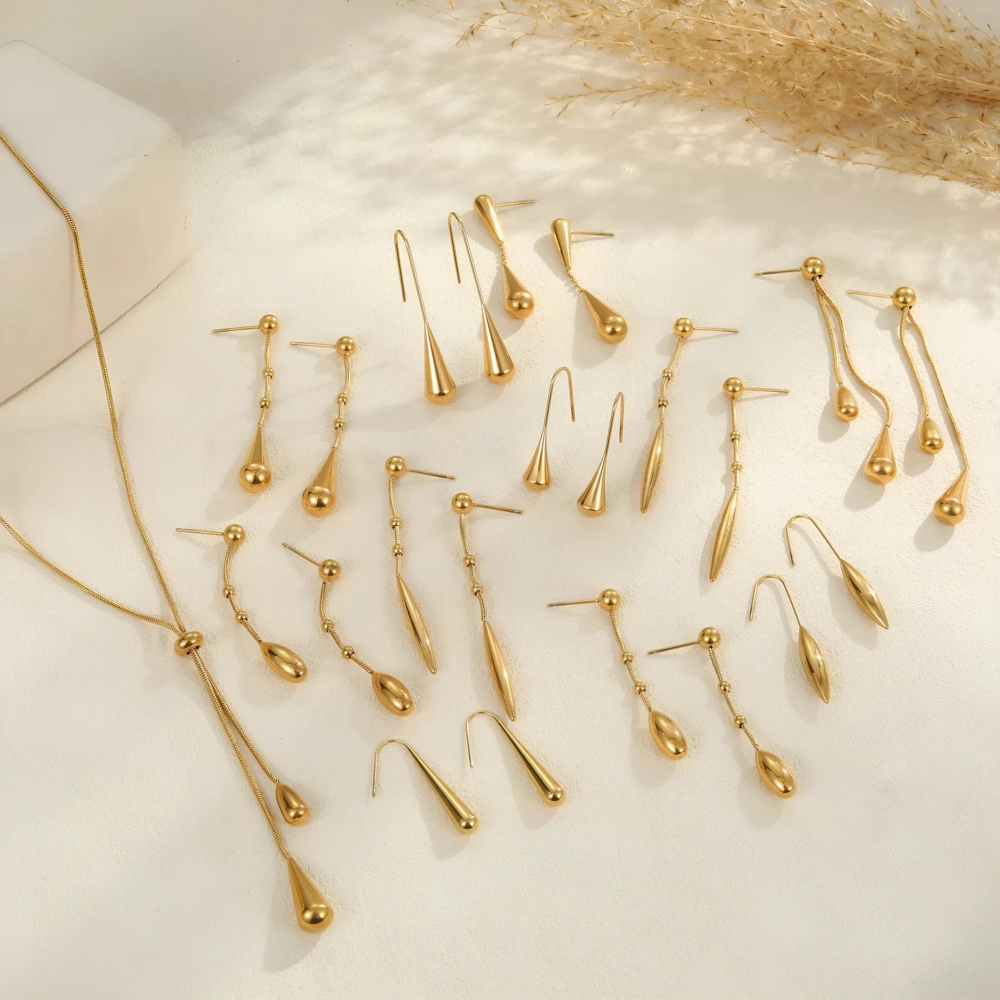 Stainless steel tassel water drop earrings with Y-word chain ornament in 18K gold electroplated finish, geometric drop-shaped design