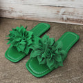 Flat flip-flops with flower decoration in faux leather and rubber sole in black colour for women