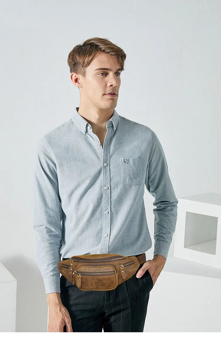 Brown leather shoulder messenger bag with a single strap and magnetic buckle closure.