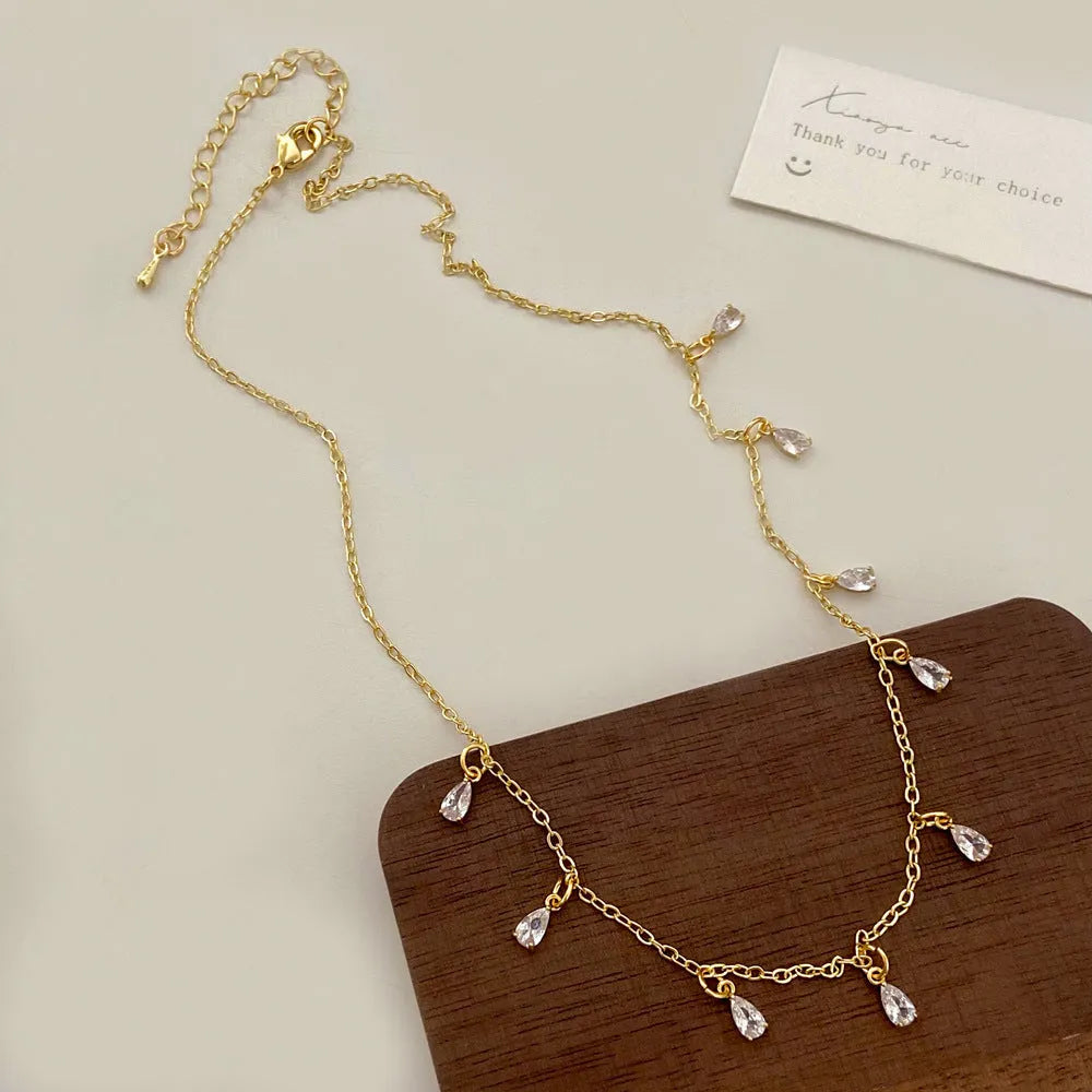 Zircon necklace, earrings, and anklet set with geometric meteor shower design on a regular chain.