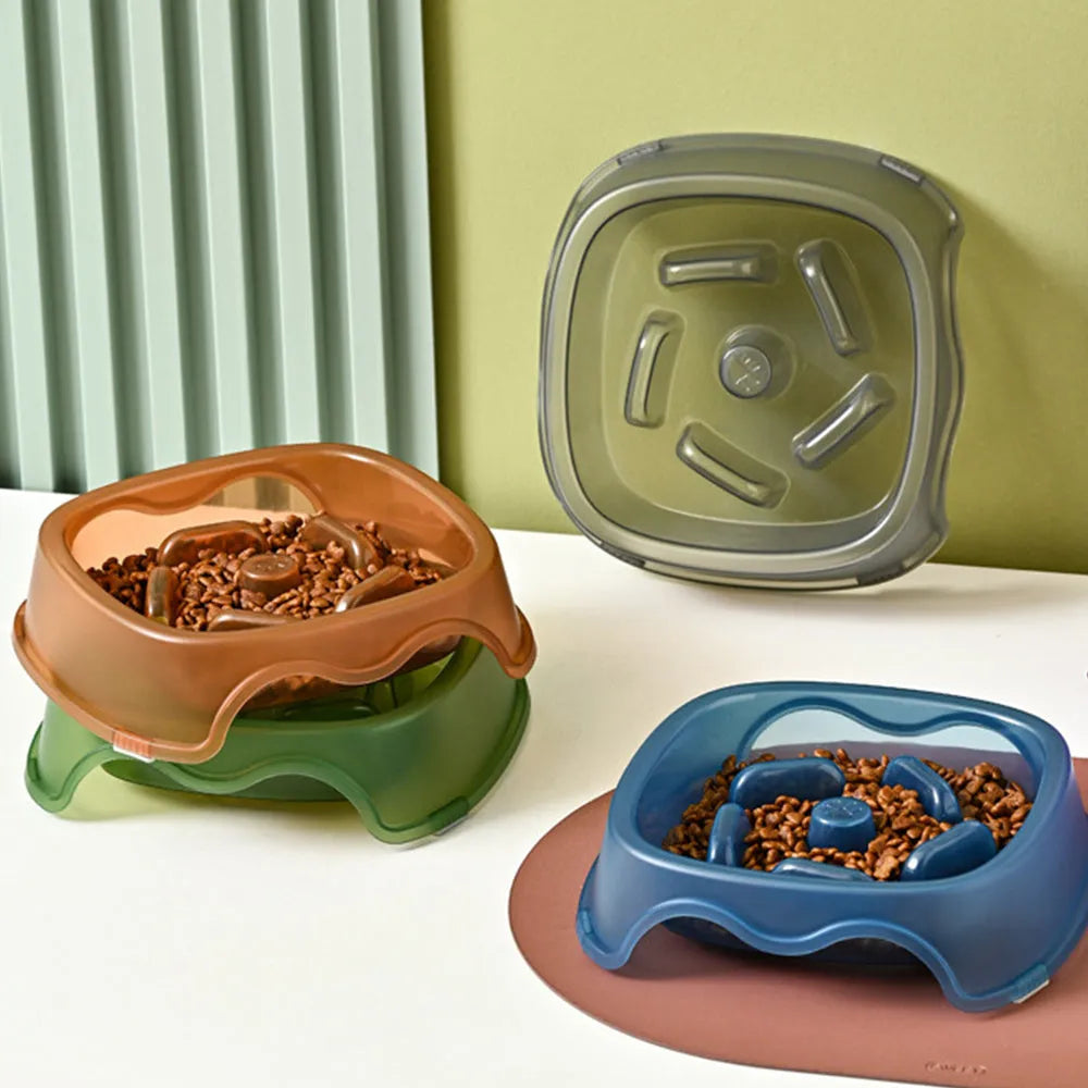 Blue plastic slow feeder dog bowl for anti-choking feeding on a plain surface.