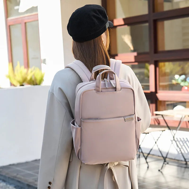 Women's canvas travel backpack showing organisational compartments and breathable design in apricot colour