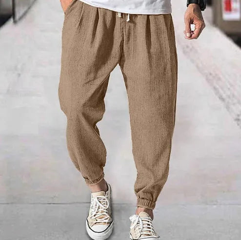 Men's cotton ankle banded trousers in light green colour showing loose fit and summer casual styling