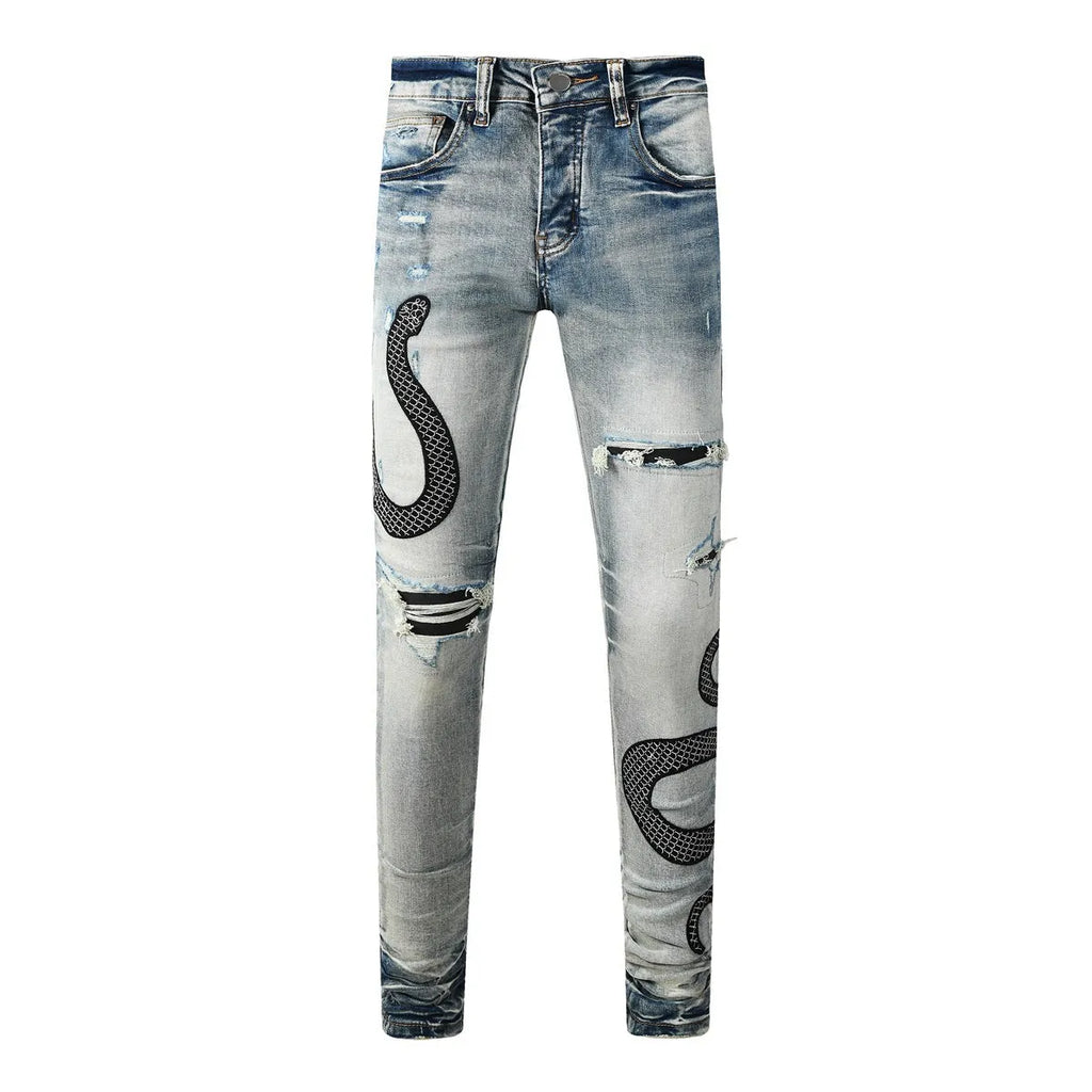 Close-up of wash distressed blue skinny jeans with a button fly and retro styling on a hanger.