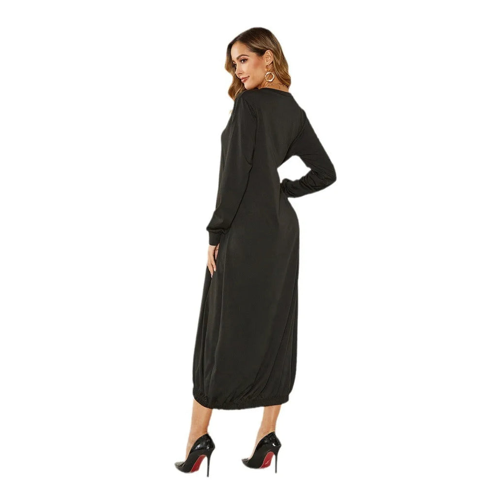 Loose-fitting black lantern dress with a crew neck and lace-up front detail on a mannequin.