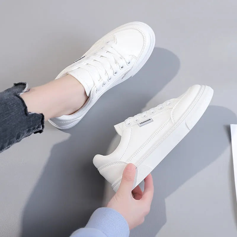 Korean style white low-top women's sneakers with a PU upper on a plain background.