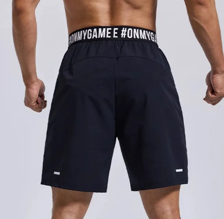 Men's black breathable sports shorts with elastic waistband and loose cropped design