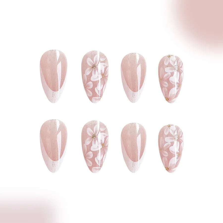 Short almond-shaped false nails with glossy French tip and glitter flower decoration, colour C625.