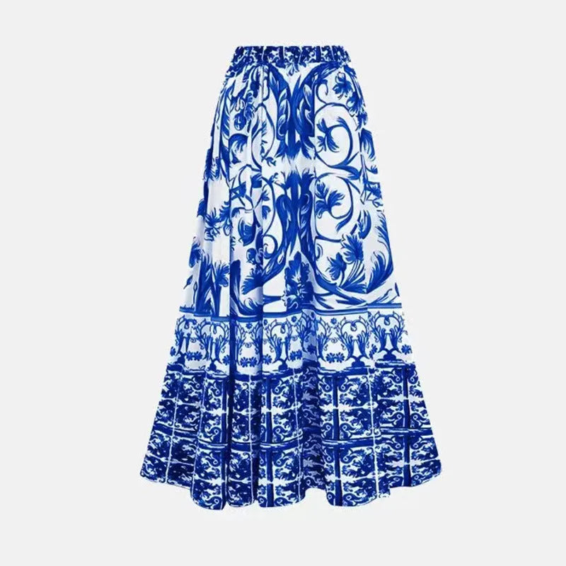 Adult woman modelling a printed one-piece swimsuit with a skirt detail in a blue colour.
