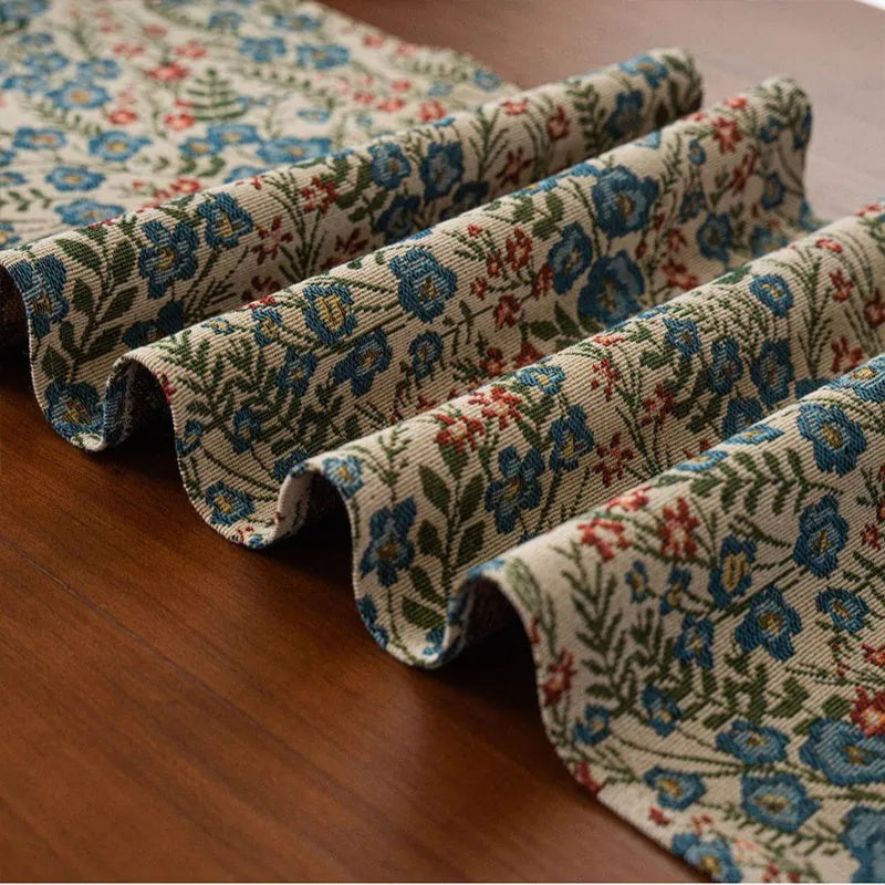 Nordic jacquard bouquet pattern table runner with decorative tassel trim in dark blue colour
