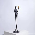 Black cast aluminum modern character desktop sculpture measuring 51cm tall.