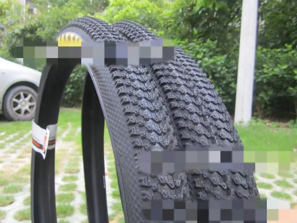 Ultralight puncture-proof mountain bike tyre shown in black with white label sidewall option.