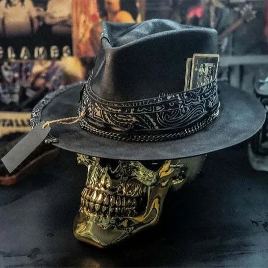 Handmade black skull hat with conical crown, made from wool and denim fabric, on a neutral background.