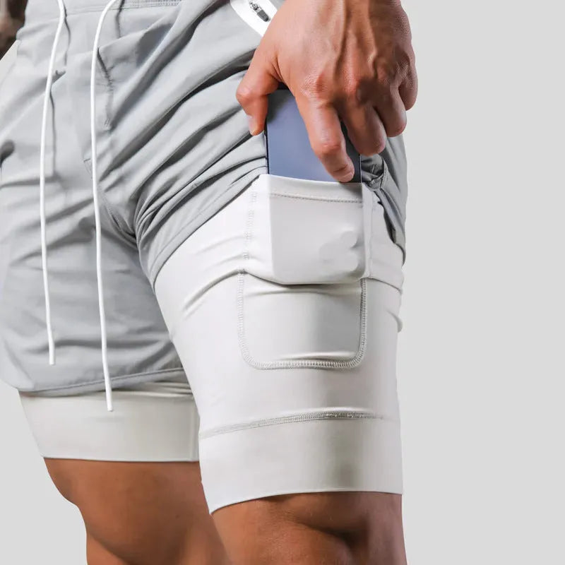 Men's double layer running shorts in light slate green and black, with built-in lining and mid-rise waist for fitness use
