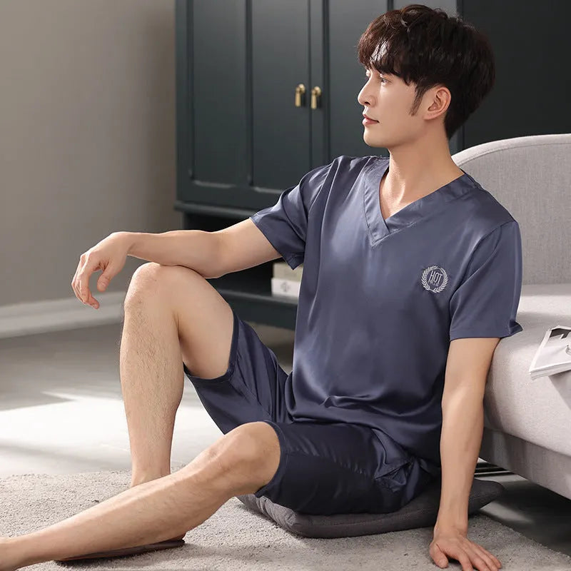Man's light blue ice silk short-sleeve pajama shirt and loose matching shorts laid flat