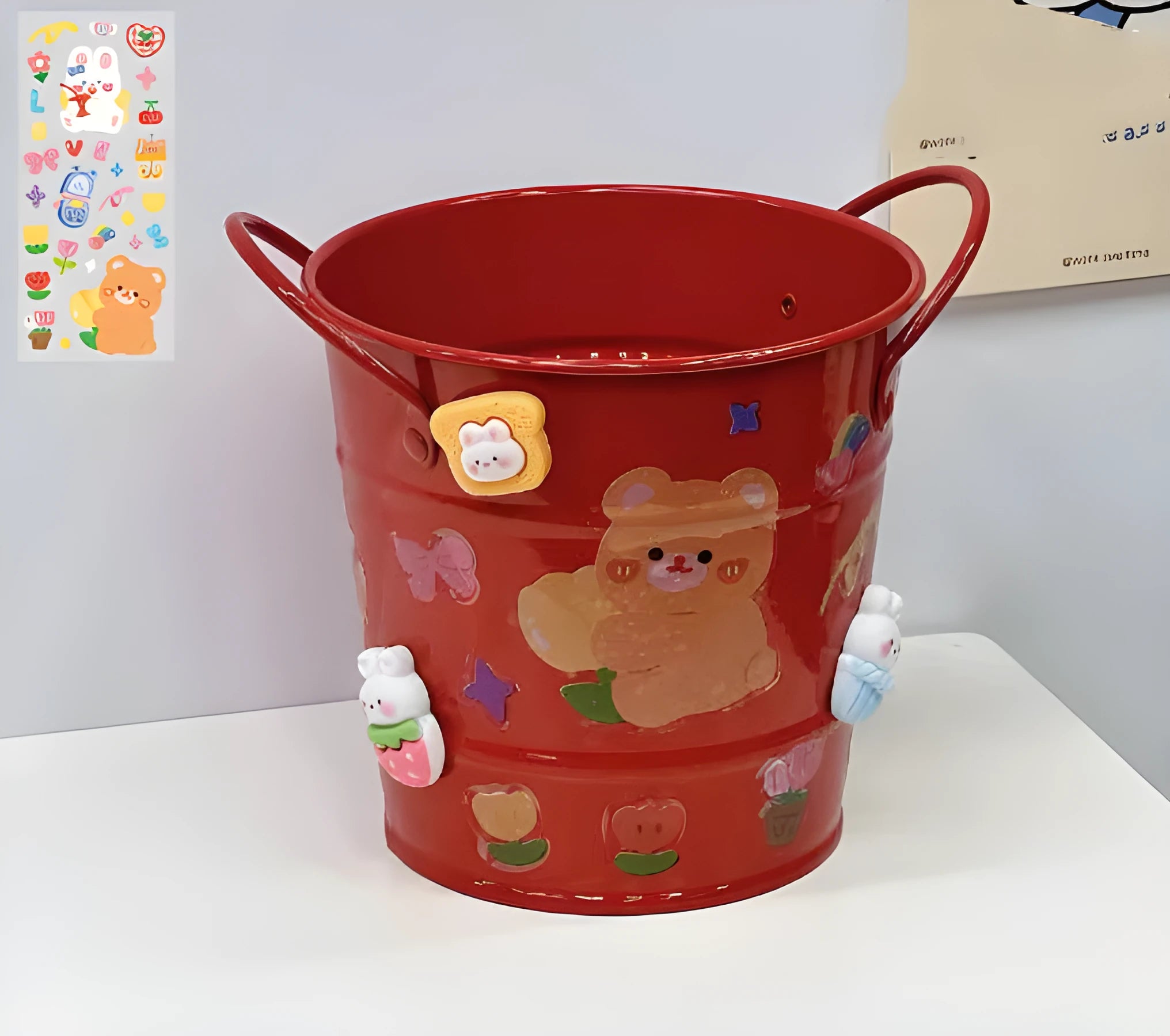Round metal desktop pen holder showing colour options including green, pink, red, white and yellow