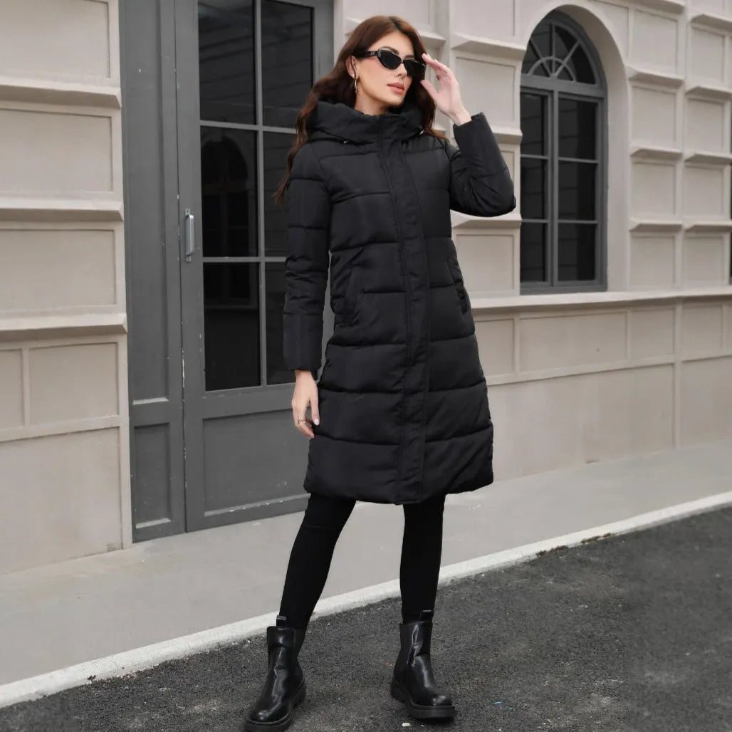 Black slim-fit hooded long cotton jacket for men on a hanger.