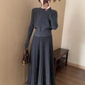 Dark grey knitted two-piece suit with 3D textured patterns, showing sweater and matching skirt