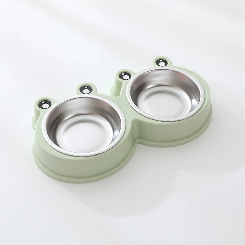 Frog-shaped plastic holder containing two stainless steel pet bowls for food and water.