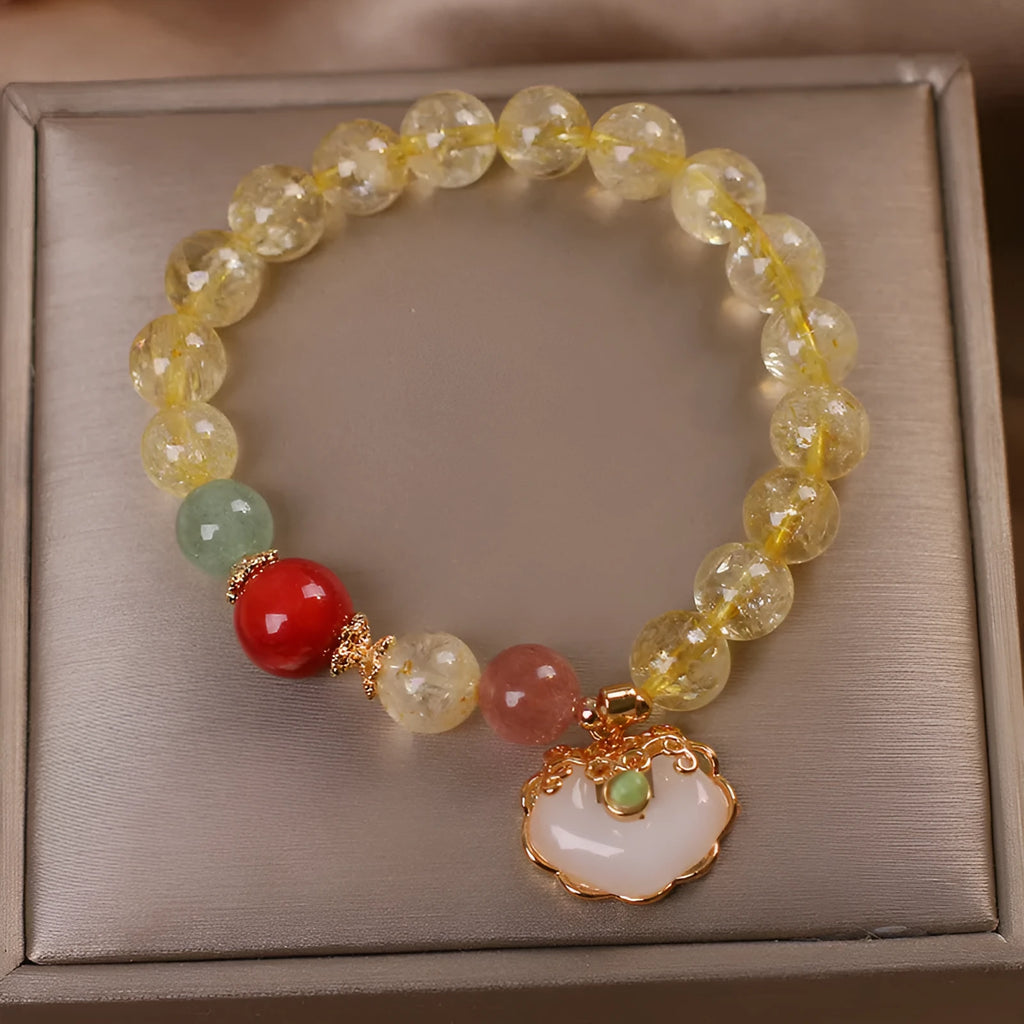 Women's pendant bracelet with a yellow natural citrine jade ruyi charm on an alloy chain.