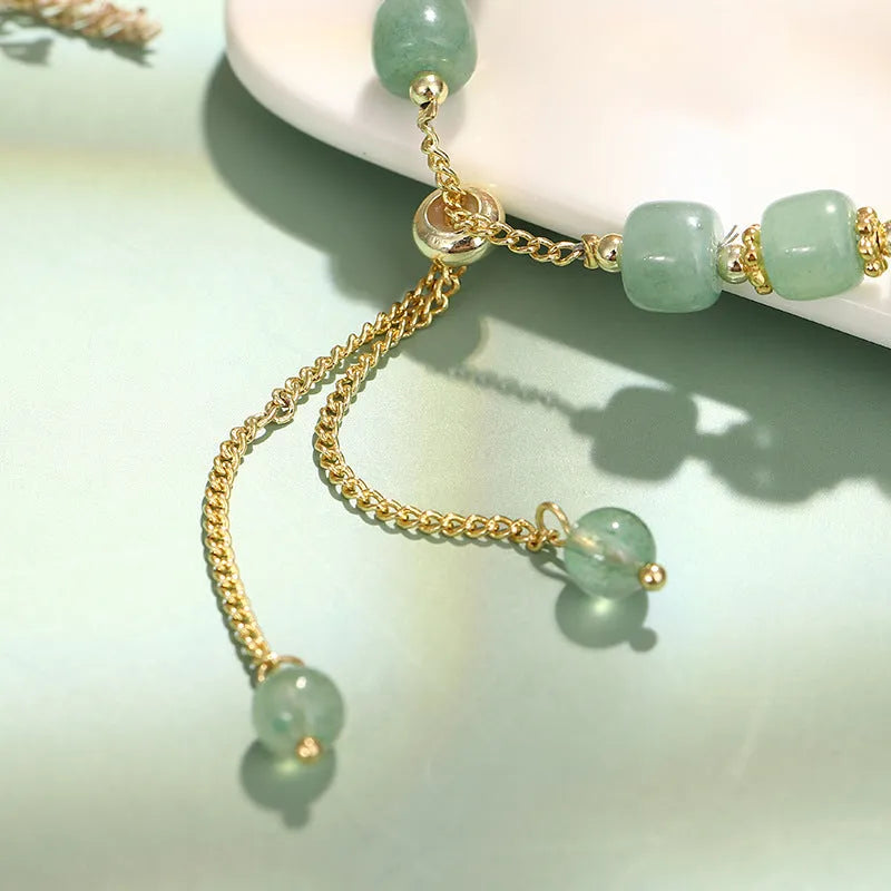 Green aventurine and strawberry quartz rabbit charm bracelet for women with copper and gold details