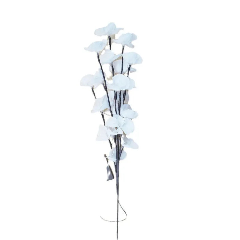 Pink LED Phalaenopsis branch decorative light on a table, 65cm long with fabric cover.