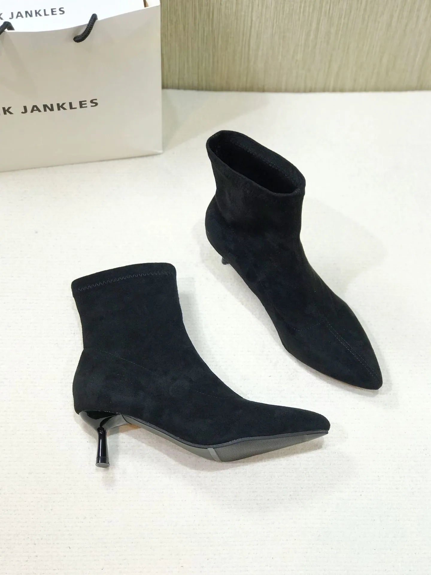 Black pointed toe women's ankle boots with stiletto heel and mid-calf height