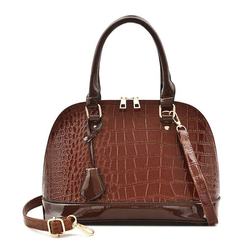 Shiny black PU crossbody bag showing structured shell shape and dimensions