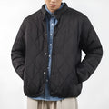 Men's black diamond lattice patterned winter jacket showing lengthened design and medium thickness padding