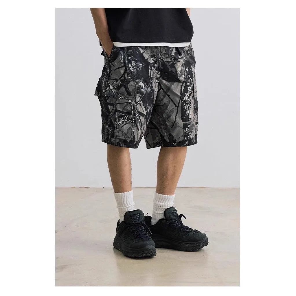 Man wearing loose straight-leg denim shorts in army green, showing mid waist and casual style.