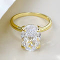 Women's oval four-claw solitaire ring with 6x9mm gemstone in gold or silver finish