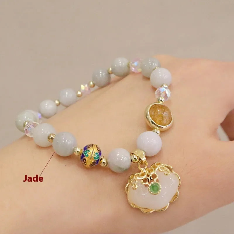 Women's bracelet with strawberry quartz and gray jade stones and ethnic metal decorations