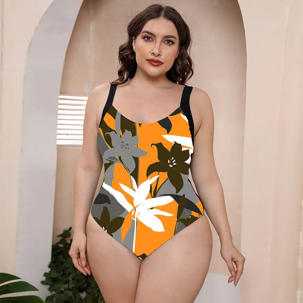 Floral print one-piece swimsuit with spaghetti straps and a conservative vest-style top.