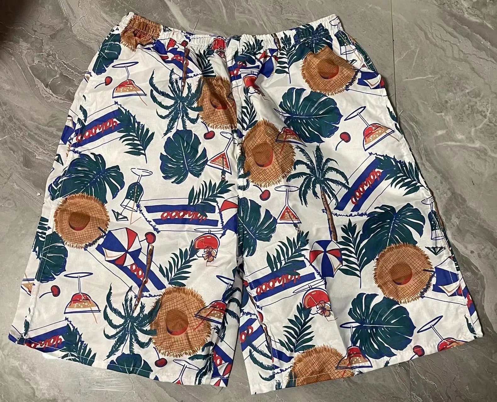 Men's floral print five-point swimming trunks in polyester, showing one of 24 available colour patterns.