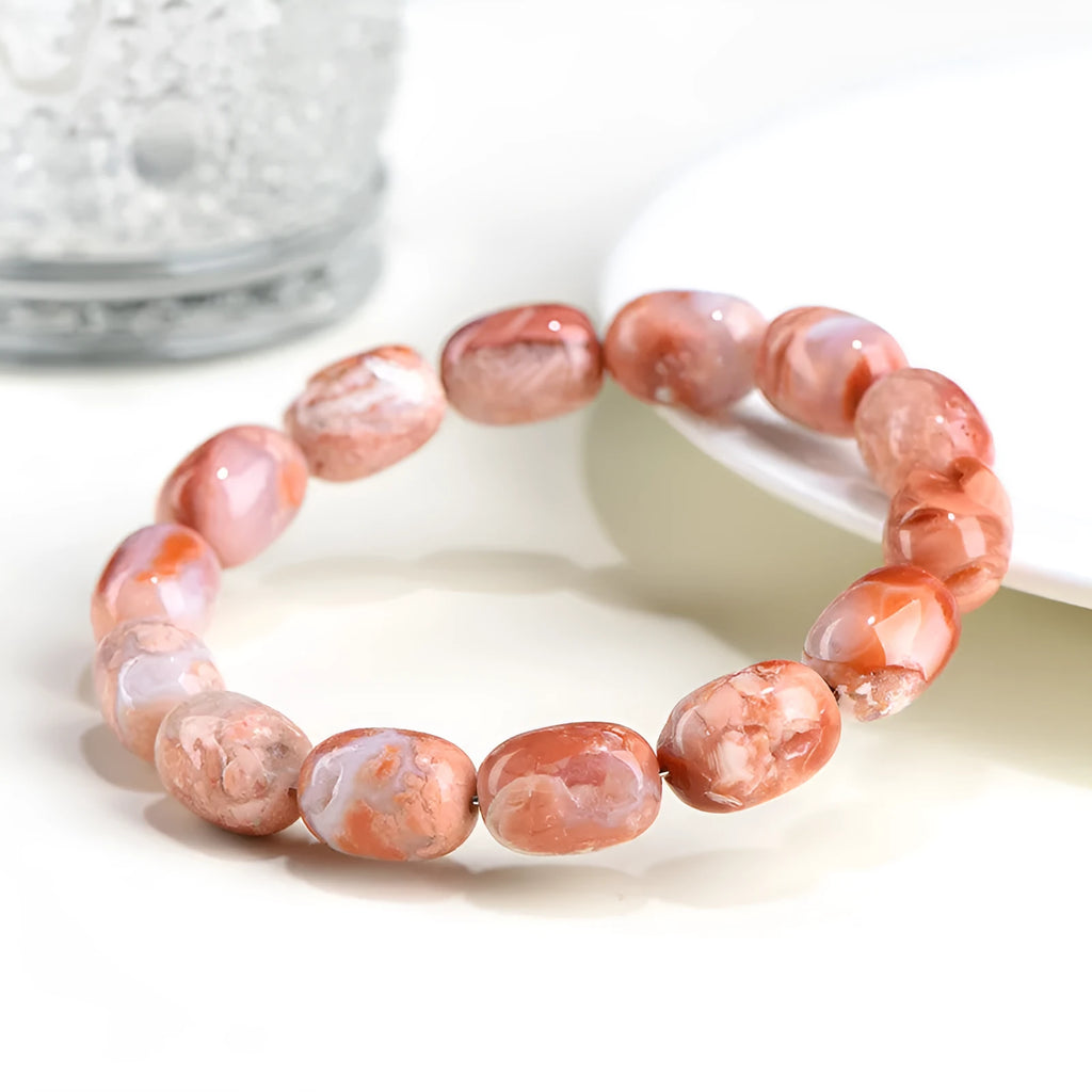 Natural cherry agate barrel bead bracelet with Ruyi decoration on white background