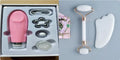 Natural white jade double-headed facial roller and gua sha scraping board set on a plain background.