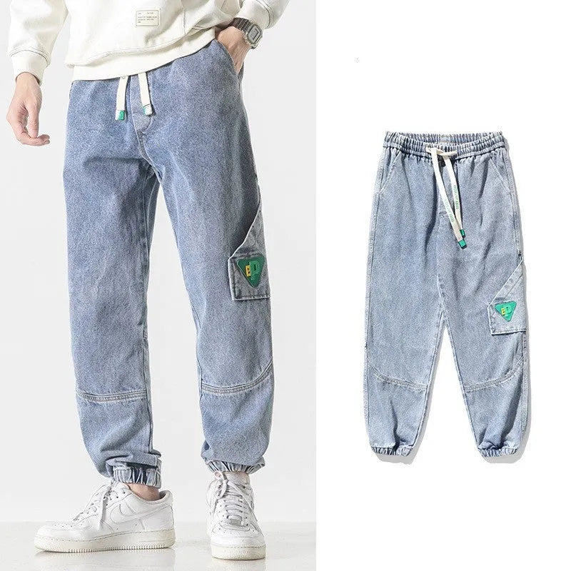 Men's loose-fit tapered cotton trousers in black showing tapered leg and mid-waist design