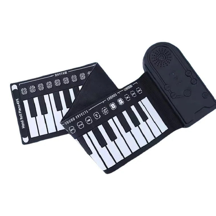 Portable folding 49-key electronic keyboard with speaker in compact rolled position showing silicone rubber keys and ABS plastic controls