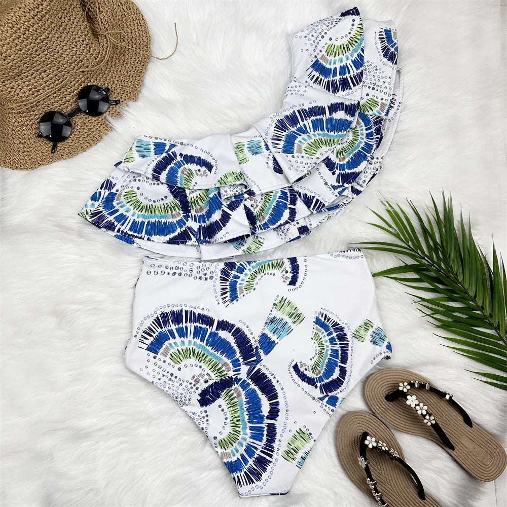 White women's swimsuit with one-shoulder design featuring large lotus leaf detailing and split hem