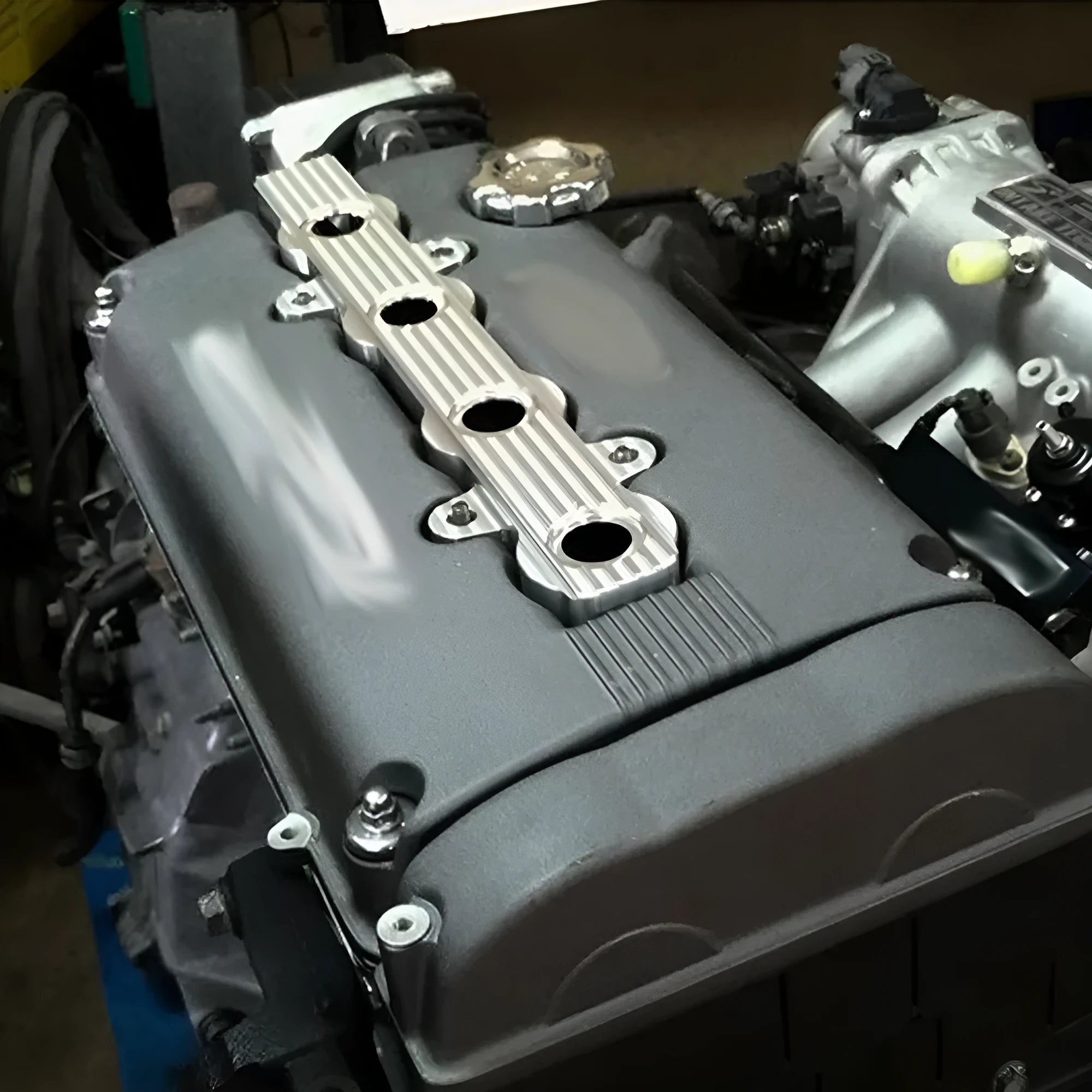 Aluminium alloy engine harness mounting bracket in blue, red, or silver finish, shown with and without holes.