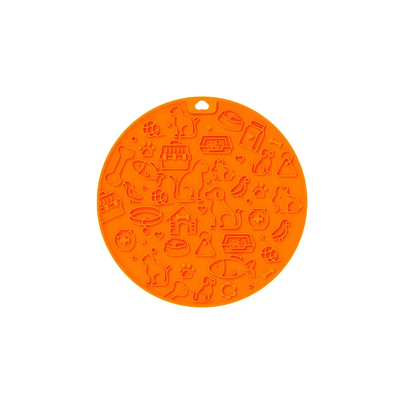 A blue silicone pet licking mat with a suction cup base on a kitchen floor.