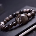 Obsidian fox charm bracelet on an adjustable leather cord for women.