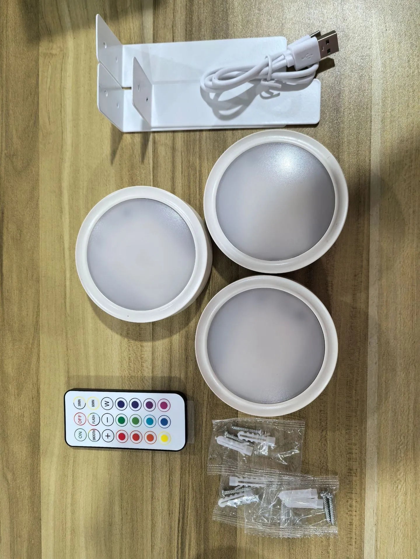 Wireless LED painting lamp with a magnetic mounting belt and remote control in black finish.