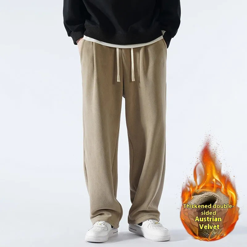 Men's double-sided polar fleece sports trousers in apricot, showing loose fit and drawstring waist.