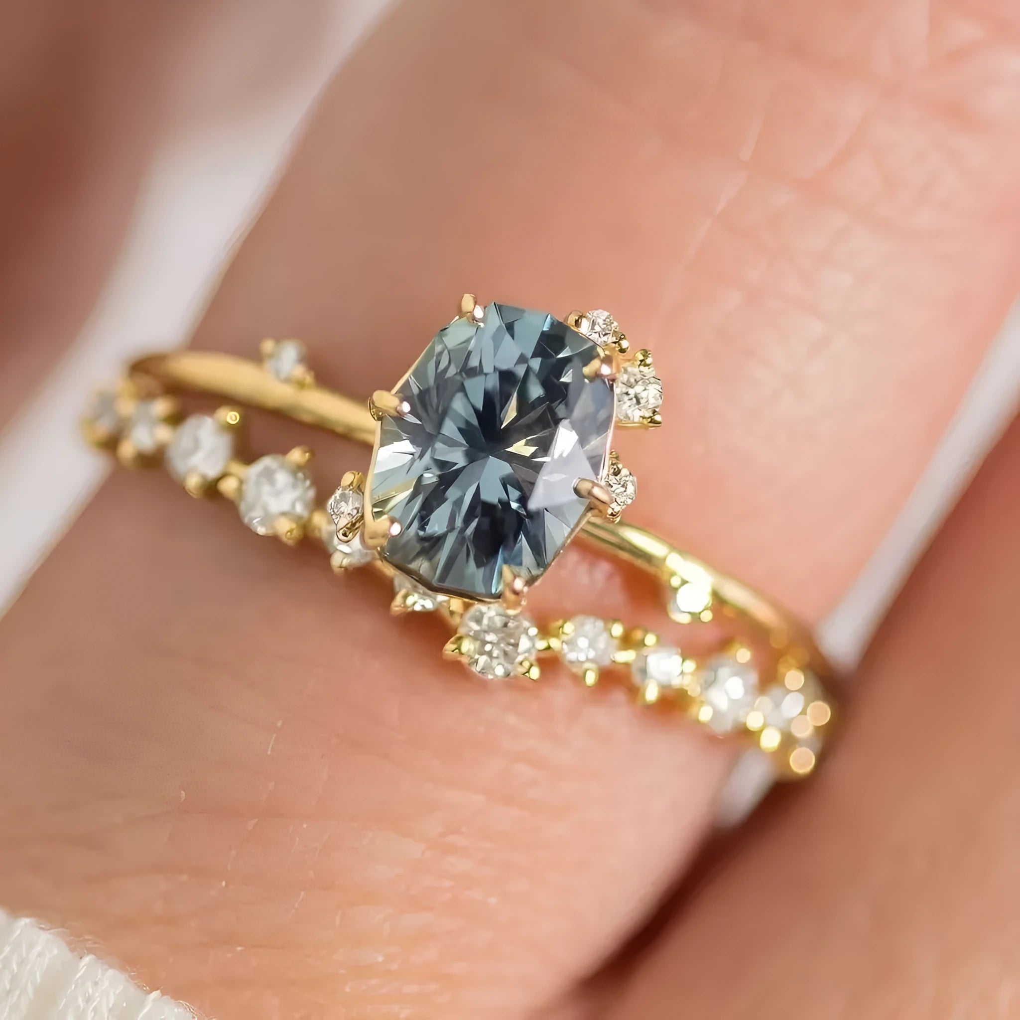 Gold plated women's ring with green zircon stone in flower-shaped design on finger