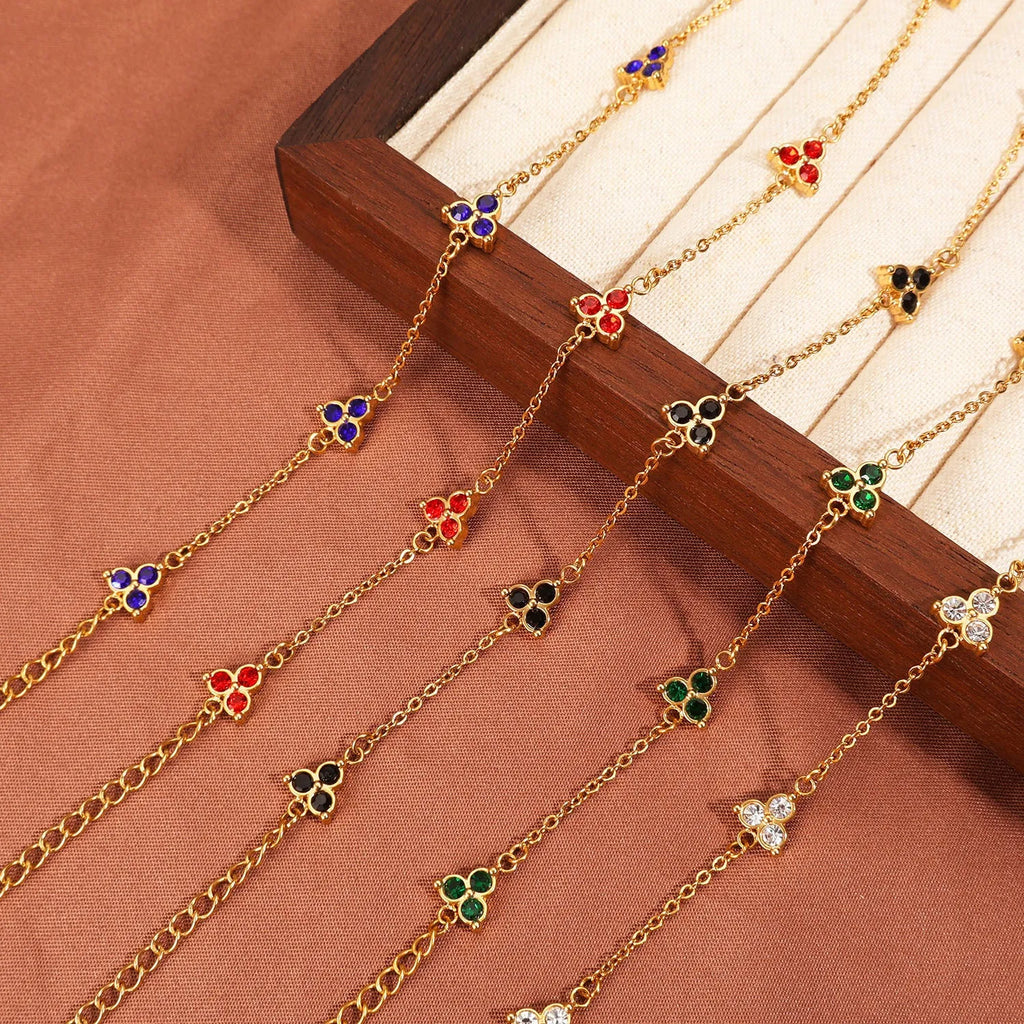 Women's stainless steel geometric bracelet with triangle design and three-diamond centrepiece in gold or steel finish.